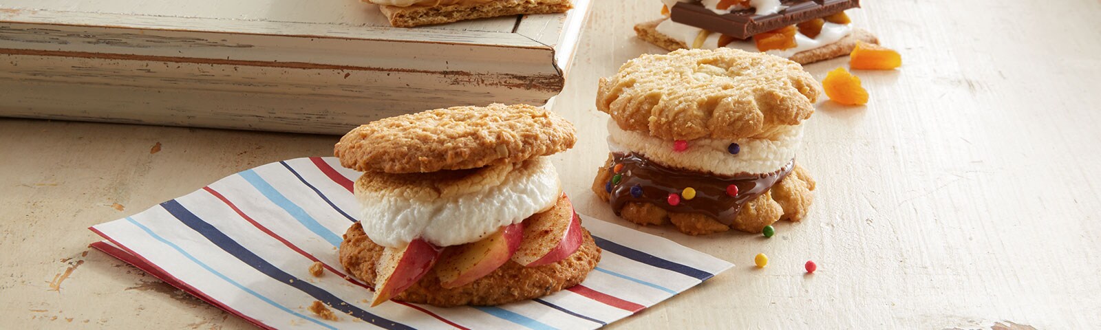 Homemade apple cinnamon and peanut butter banana s’mores on a striped napkin