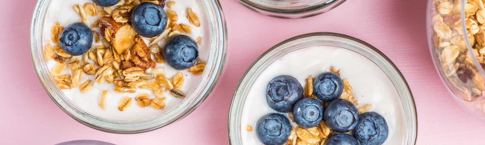 bowls of yogurt with blueberries and granola on top 