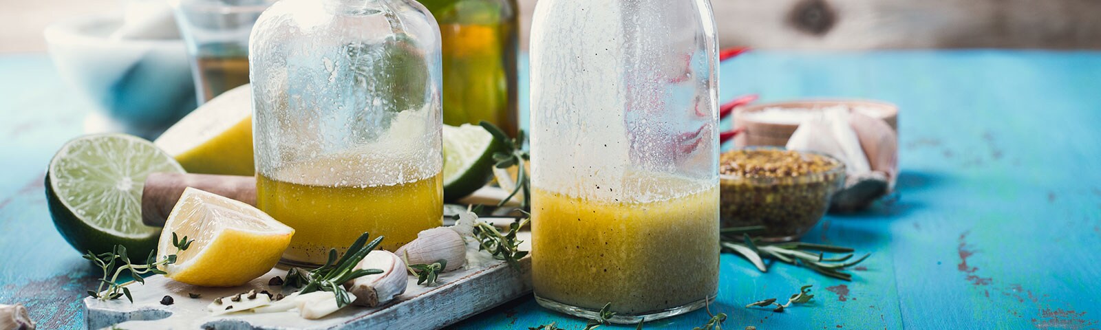 Two milk bottles filled with salad dressing Two milk bottles filled with salad dressing