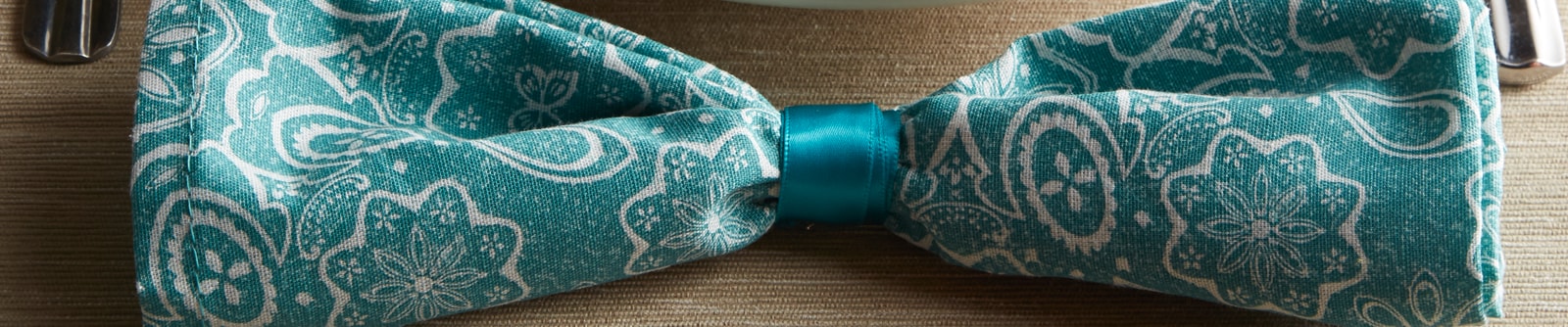 Close up of a blue paisley bow-tie