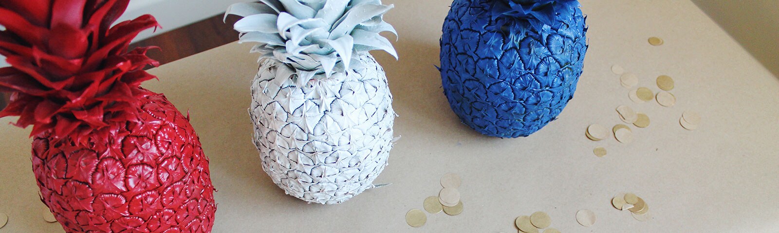 Red, White, and Blue colored pineapples on a table Red, White, and Blue colored pineapples on a table