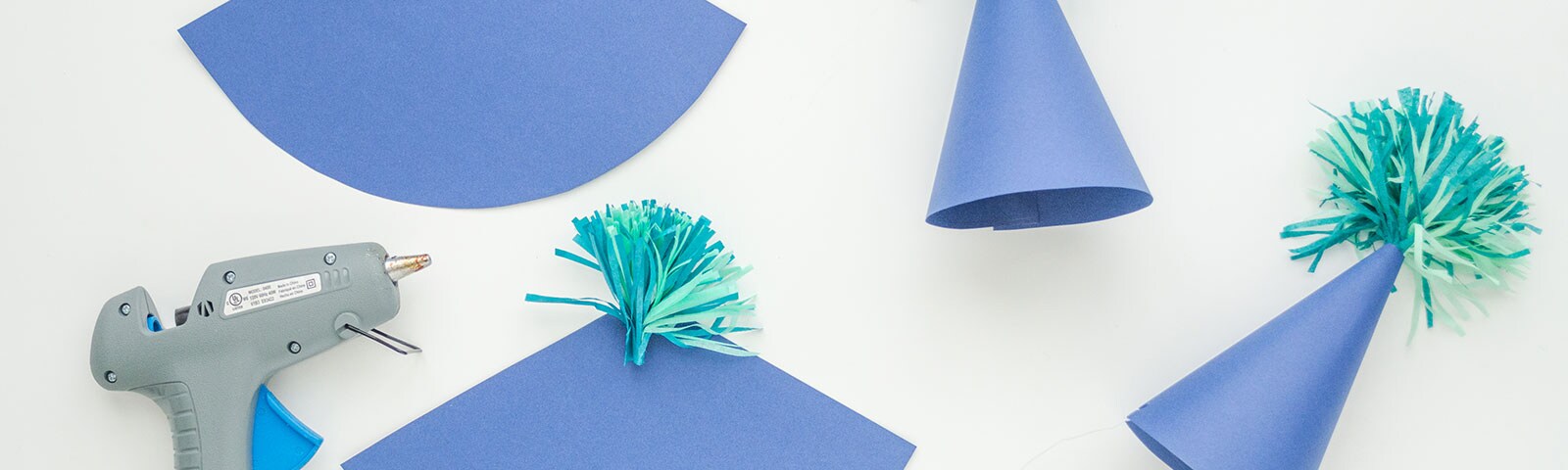 DIY blue paper hats with multi-color fringe tassels on top