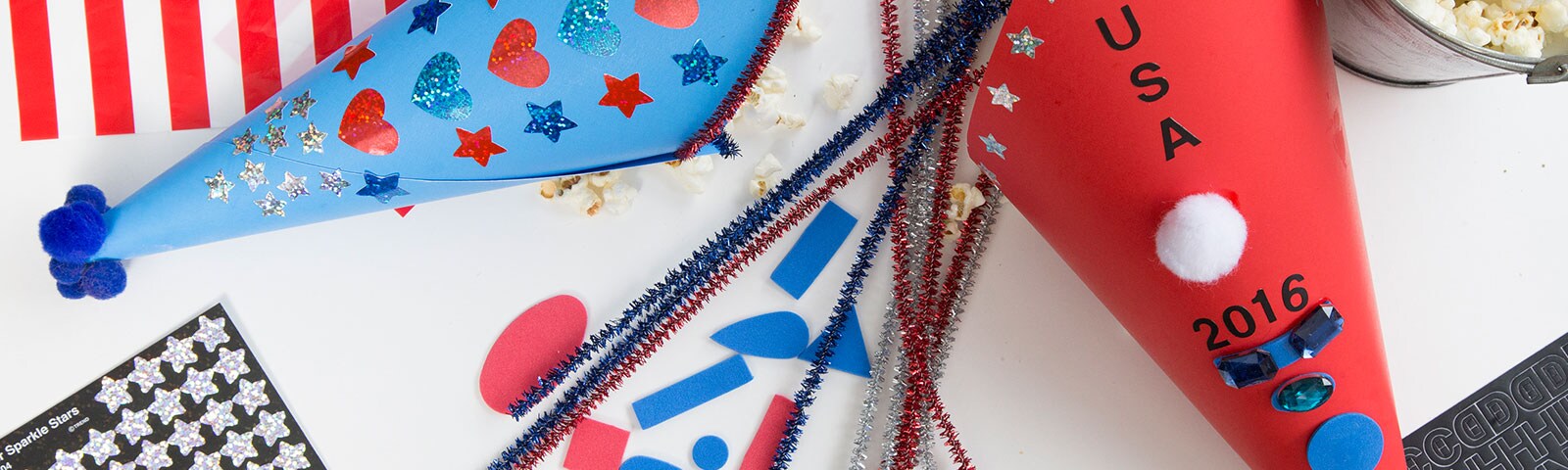 Patriotic cones with decorations like stickers, glitter and pom poms Patriotic cones with decorations like stickers, glitter and pom poms
