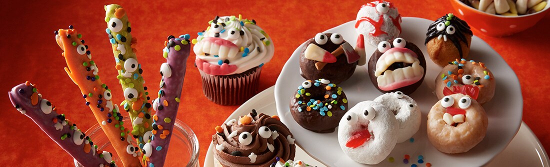 Monster themed donuts and chocolates with sprinkles Monster themed donuts and chocolates with sprinkles